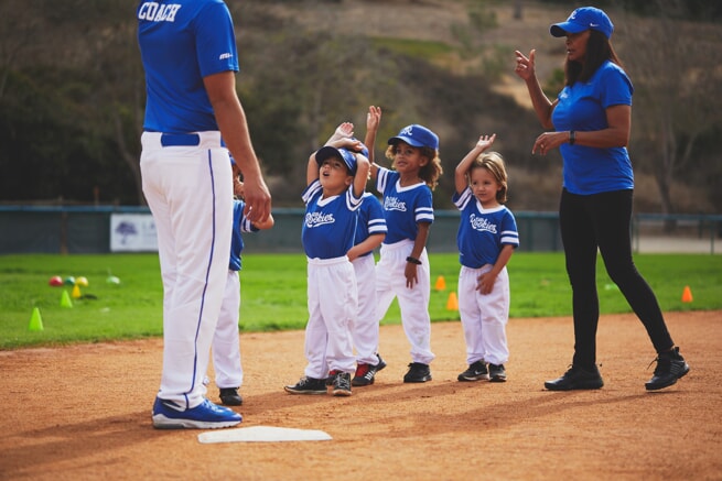 Kids running bases on baseball field