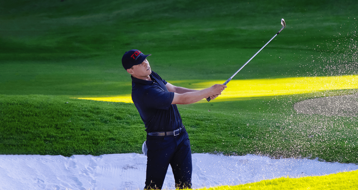 Danny Guise hitting golf ball out of sand trap